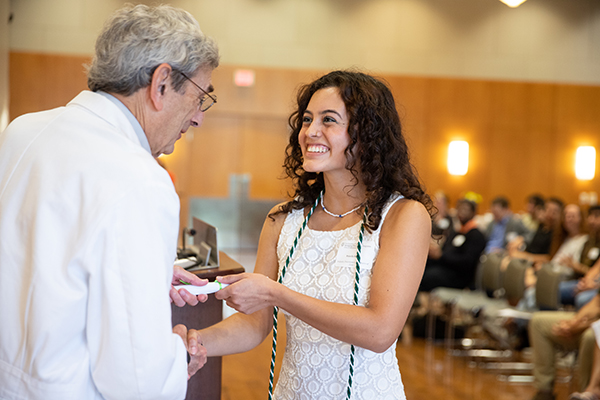 BDP graduate Priscila Khan accepting her PPCC certificate from Dr. Stephen M. Sonnenberg